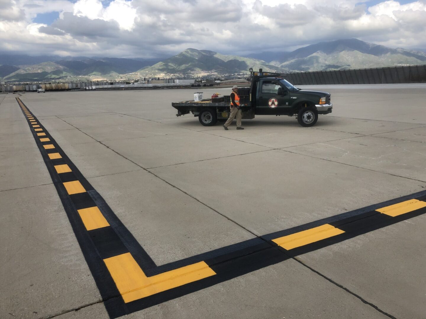 Yellow and black markings on a wide concrete field